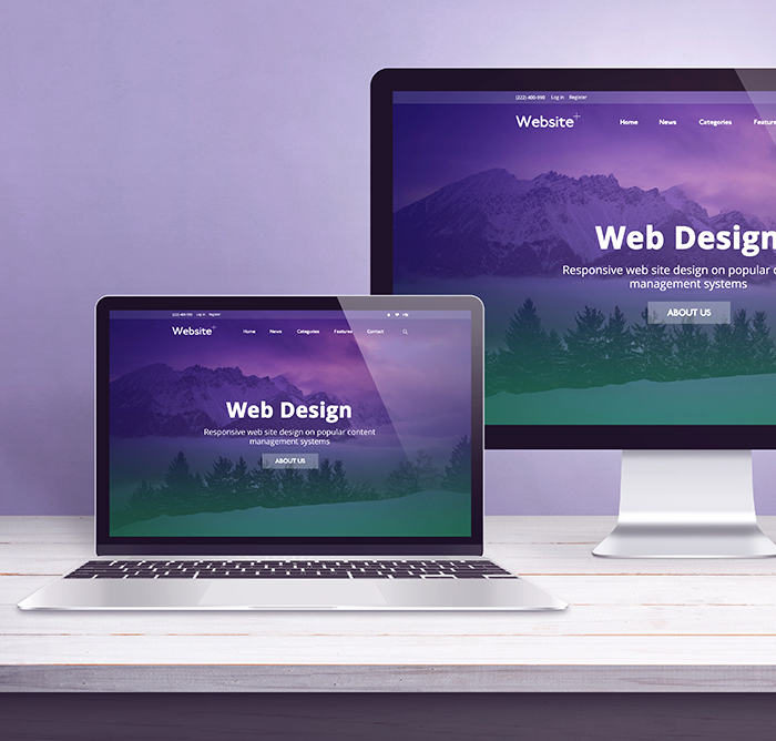 Laptop and monitor both showing a purple mountain homepage headed Web Design, responsive design on popular content management systems